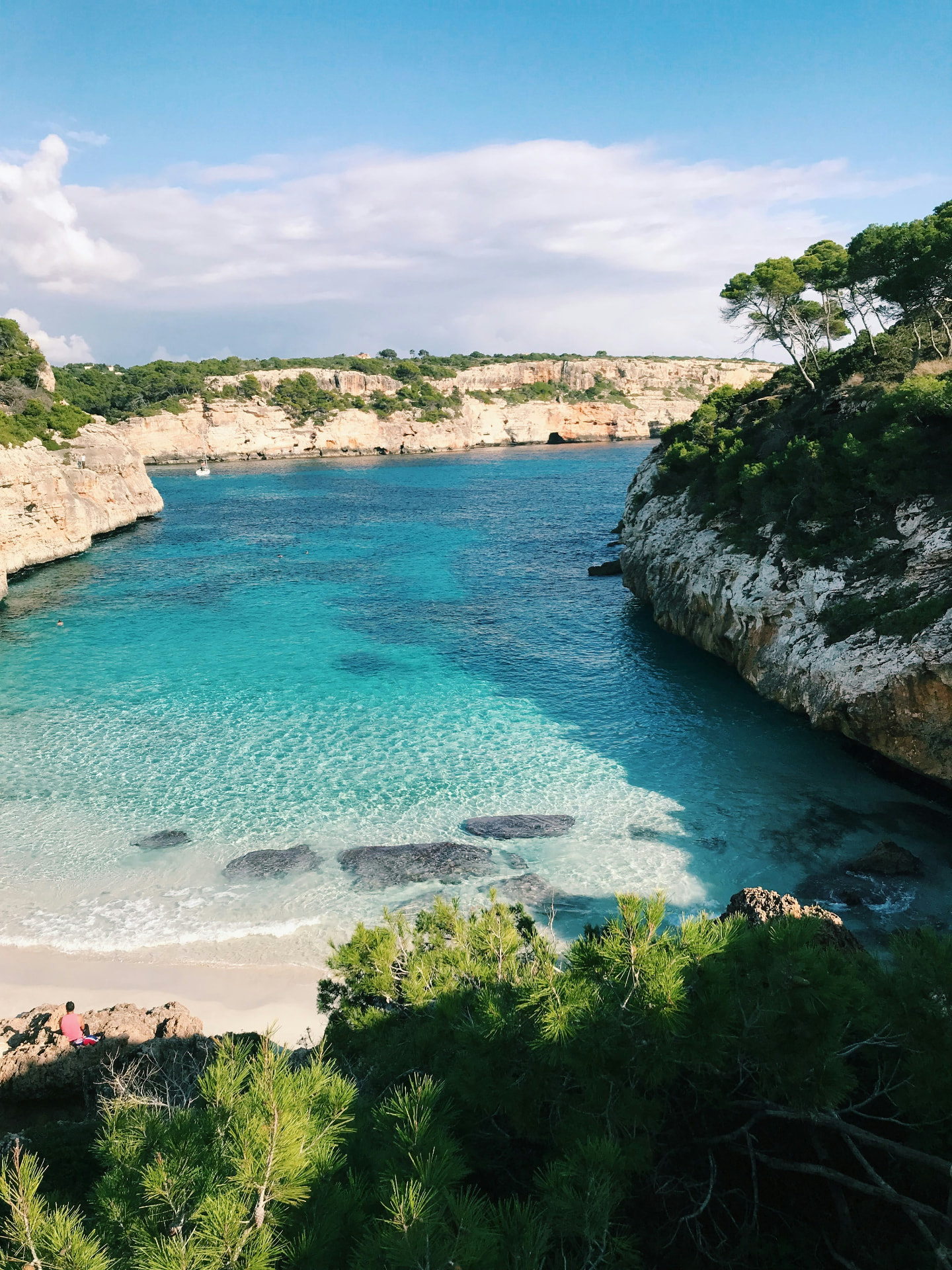 Turquoise cove with sandy beach and cliffs