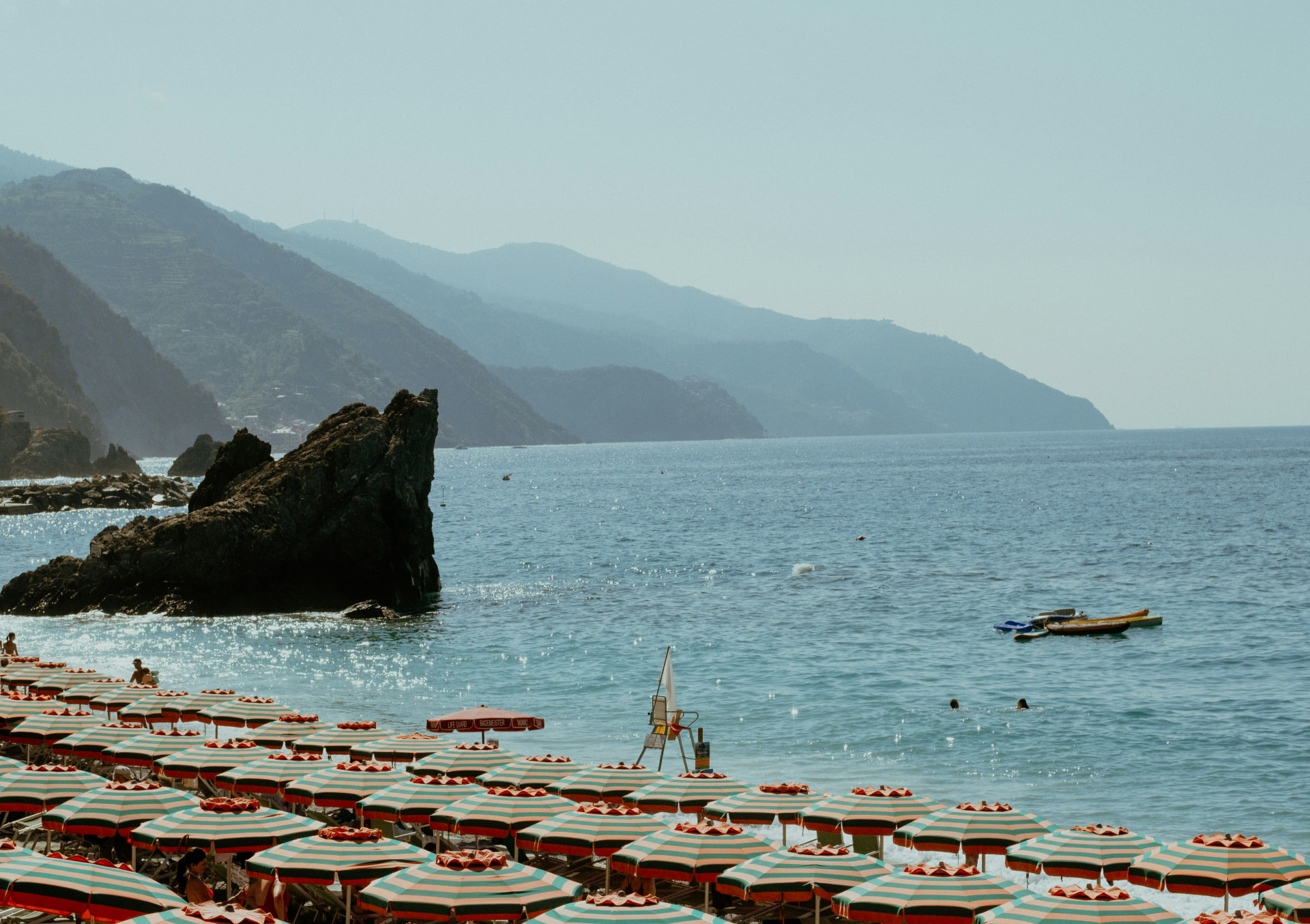 European beach with umbrellas and mountains